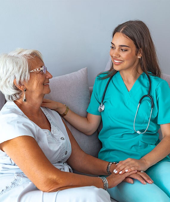 Young female nurse with elderly female